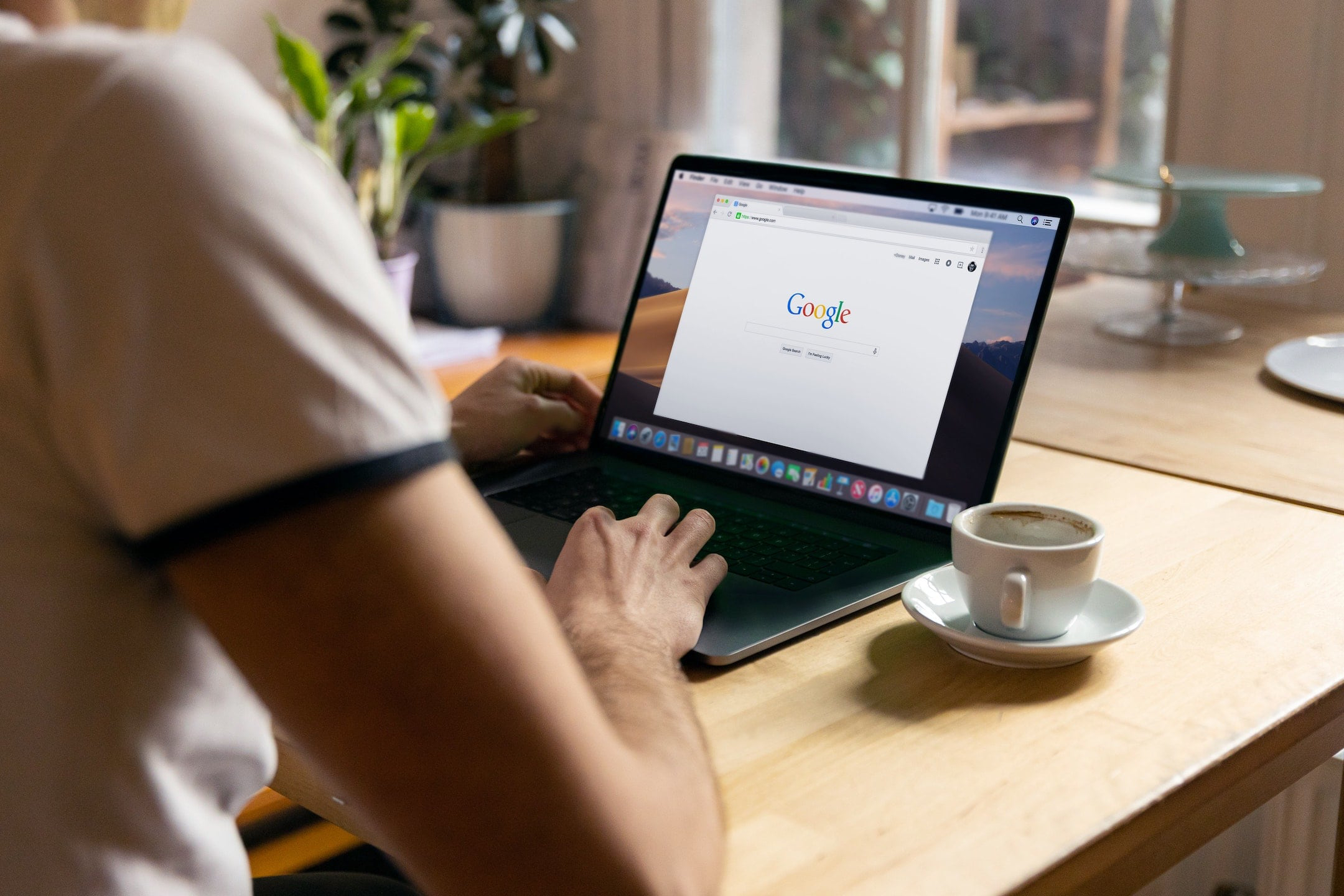 Man using laptop with google open on the screen