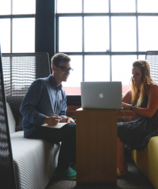 Two people looking at a laptop together