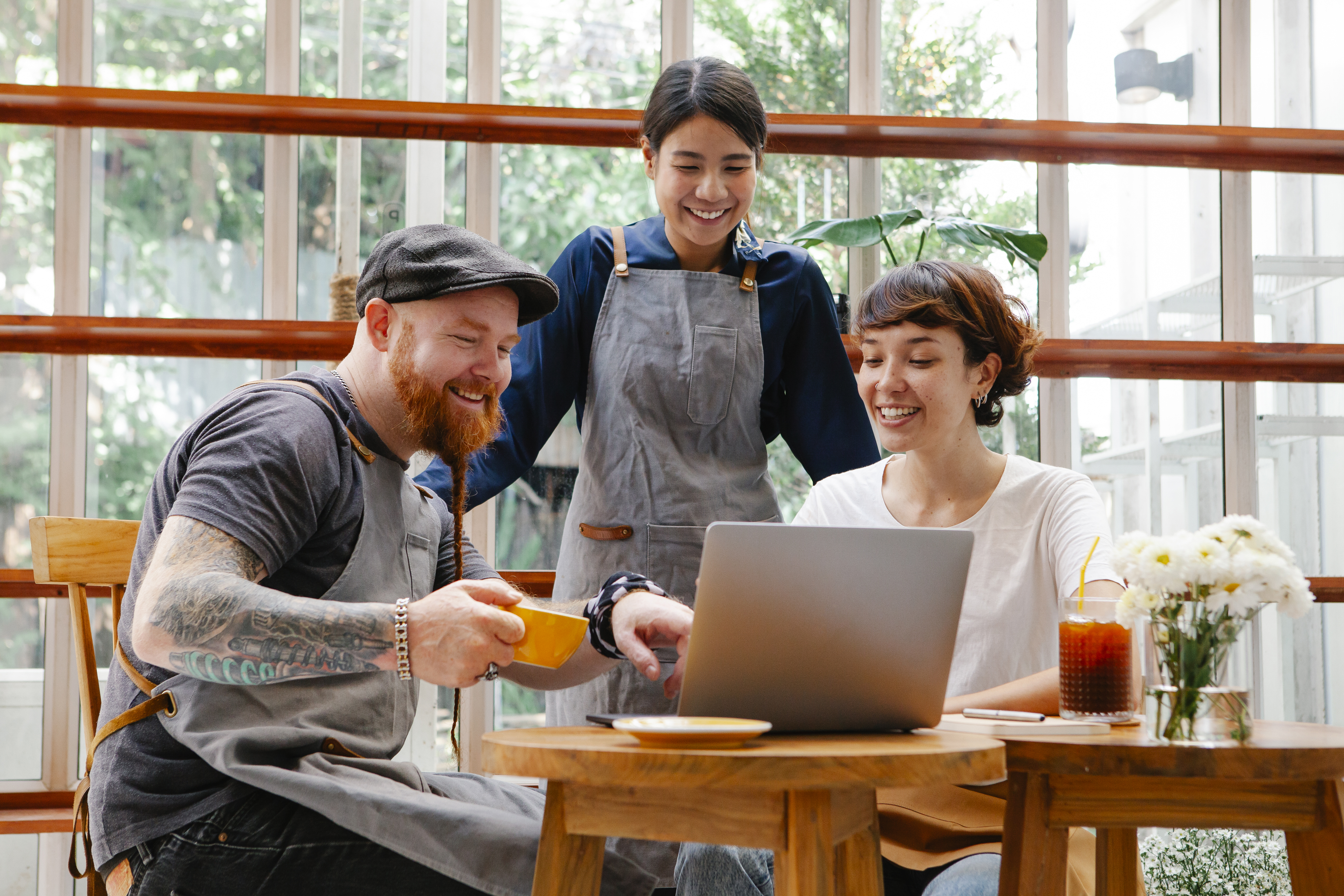 People sitting around a table with a laptop on it